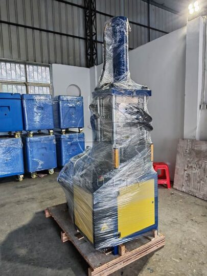 SL-120 dry ice block making machine wrapped for shipment in a factory
